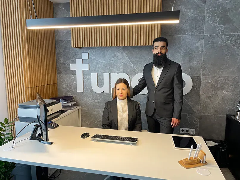 Two of our team at the front desk of our office